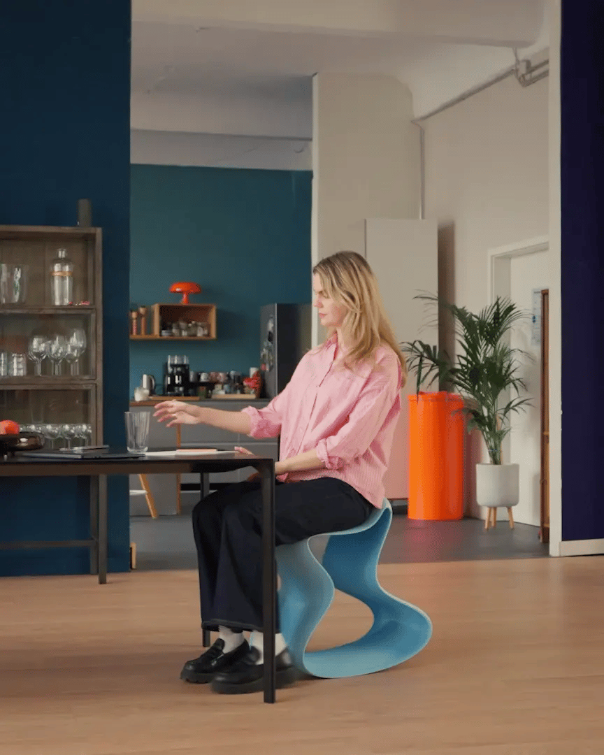 Frau arbeitet am Esstisch auf einem Flow Chair